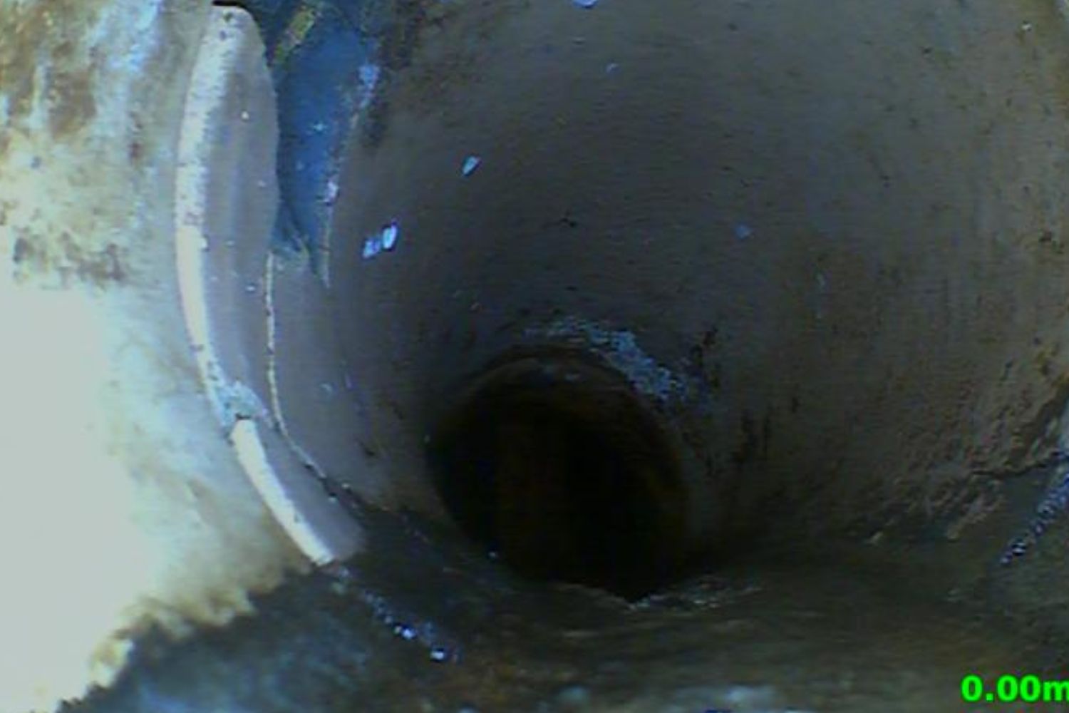 CCTV image showing the inside of a damaged drainage pipe during a survey.